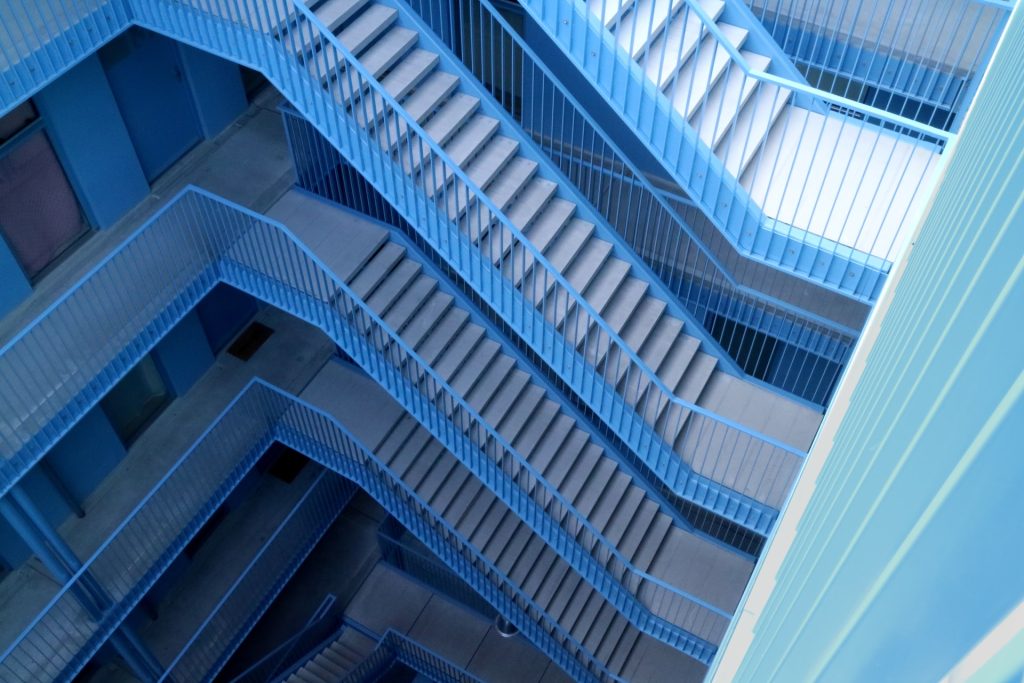 Several floors of staircases with blue railing