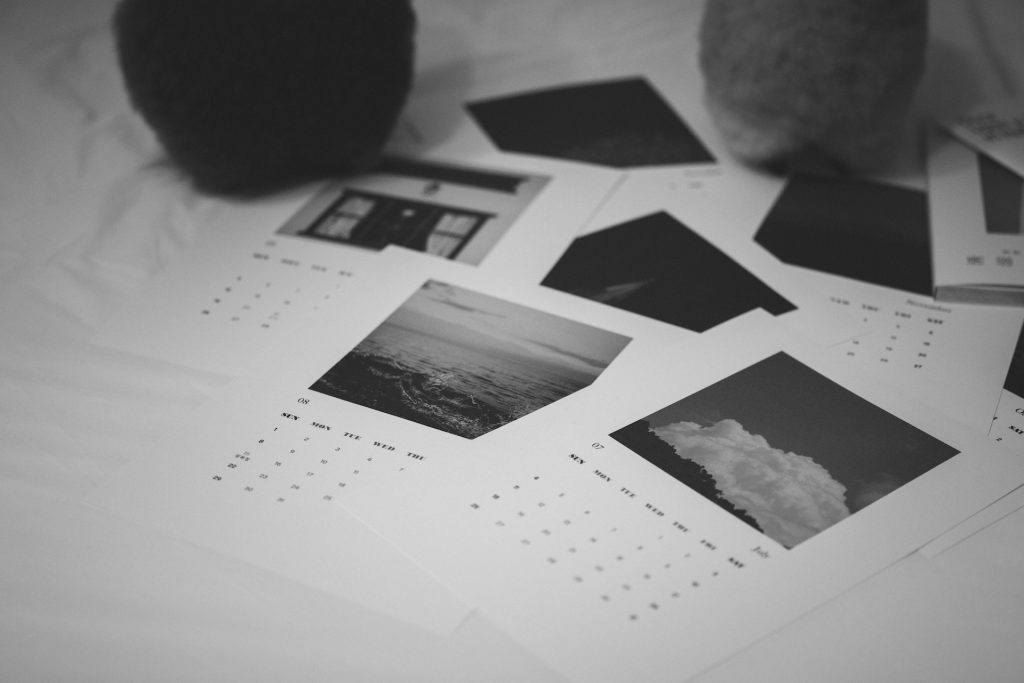 A photo of multiple monthly calendars spread out on a desk