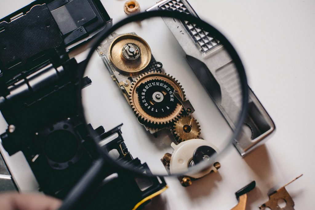 Magnifying glass showing some gears and numbers